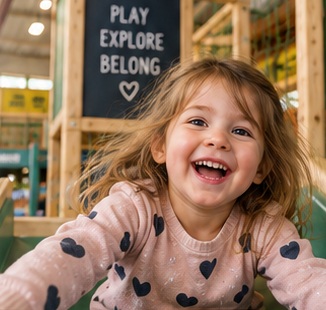 Illustrative design image of a child enjoying a slide, not a photograph of the venue
